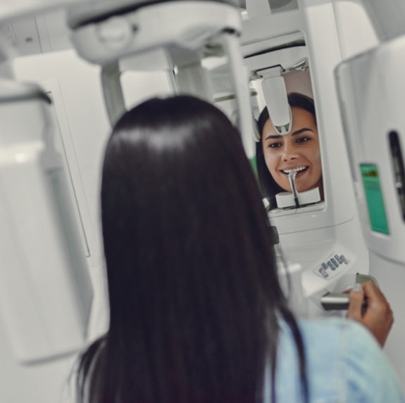 Woman getting a cone beam scan of her mouth and jaw