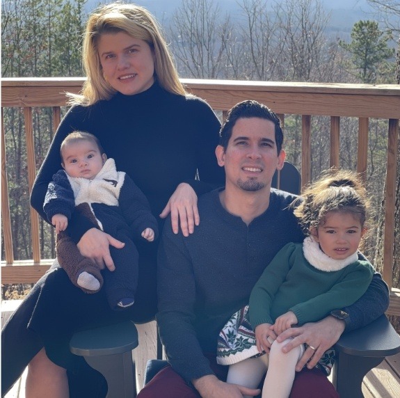 Doctor Ulloa with his wife and two children on balcony with forest in background