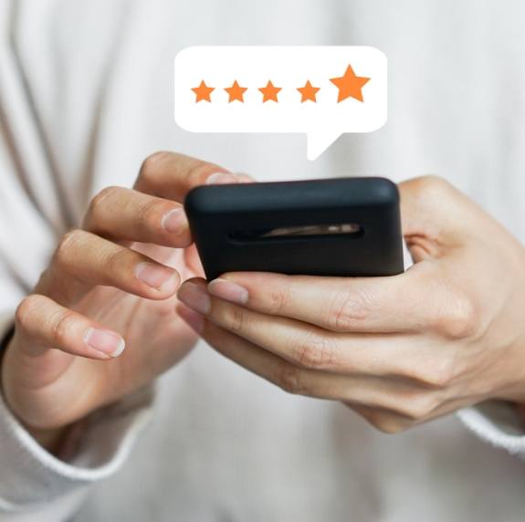 Person leaving a five star review on their phone