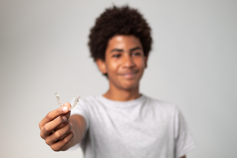 Teen smiling at school with Invisalign